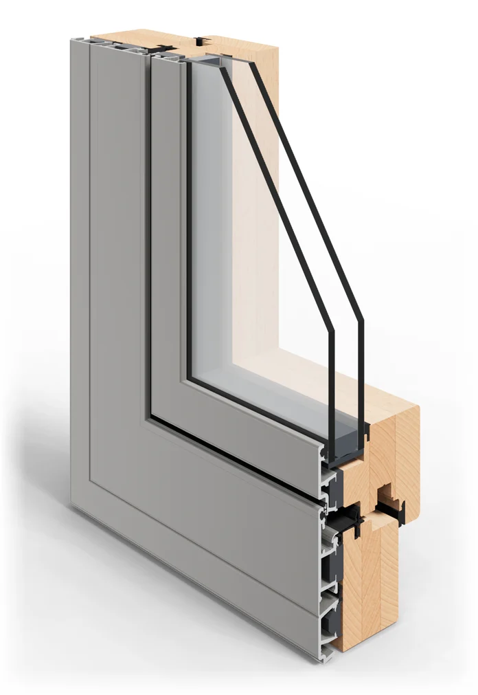 Esquina seccionada de una ventana mixta de la serie Astro 10, vista desde fuera: aluminio gris al exterior y madera de haya al interior y doble acristalamiento